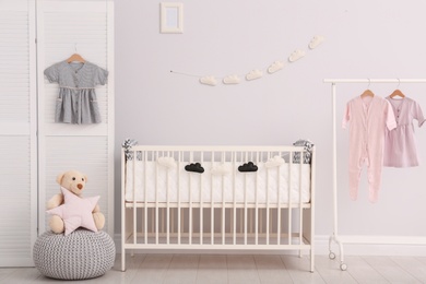 Stylish baby room interior with comfortable crib