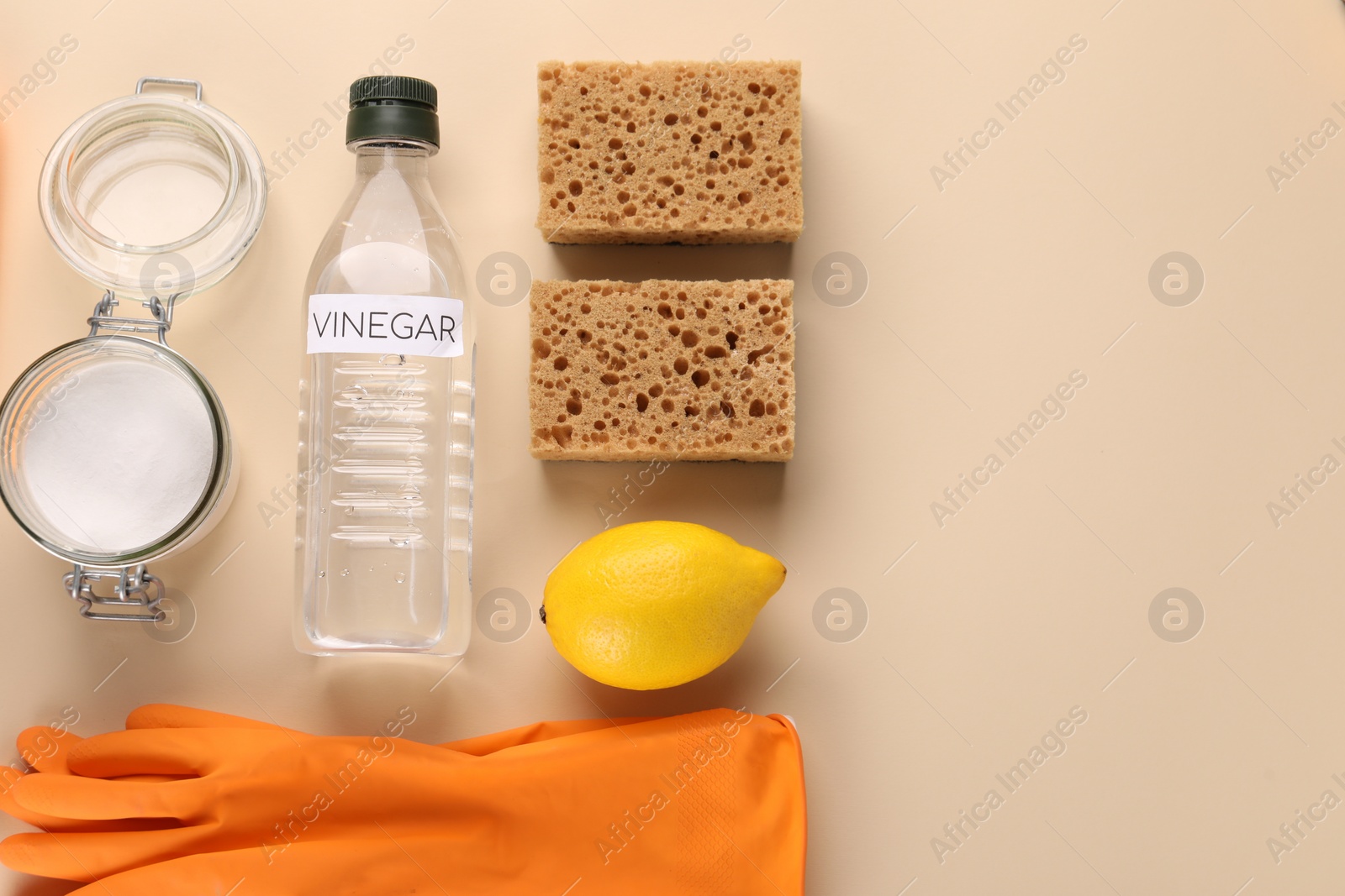 Photo of Eco friendly natural cleaners. Flat lay composition with bottle of vinegar on beige background, space for text