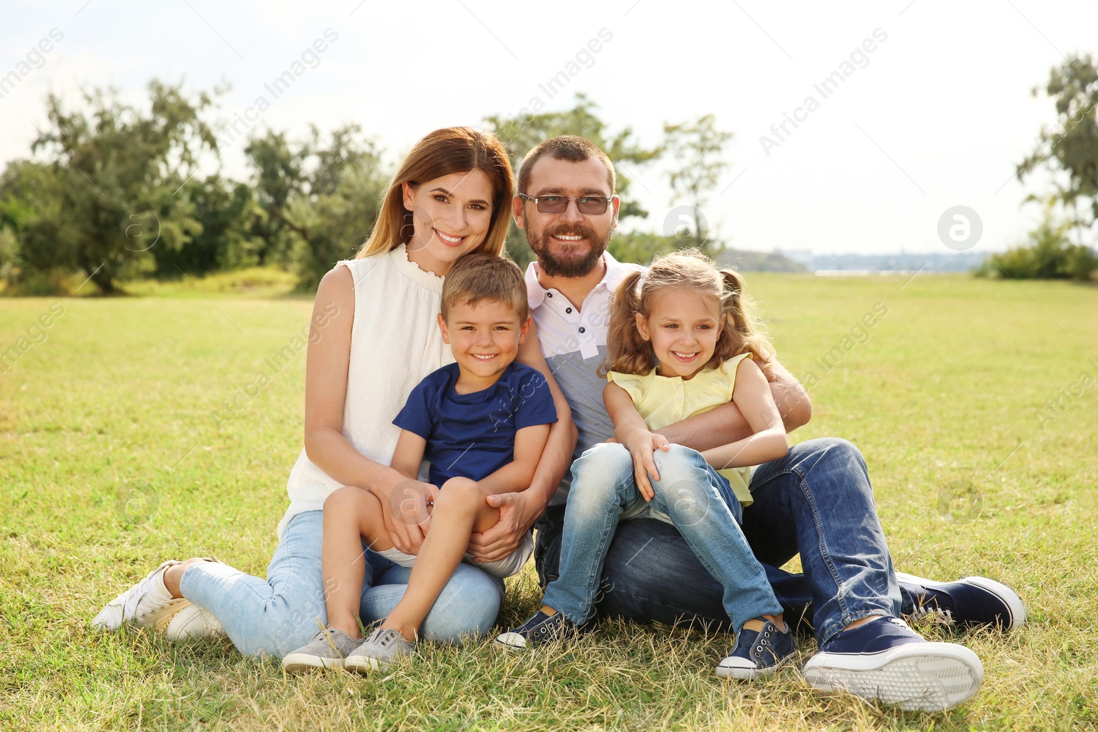 Photo of Happy family spending time together with their children outdoors