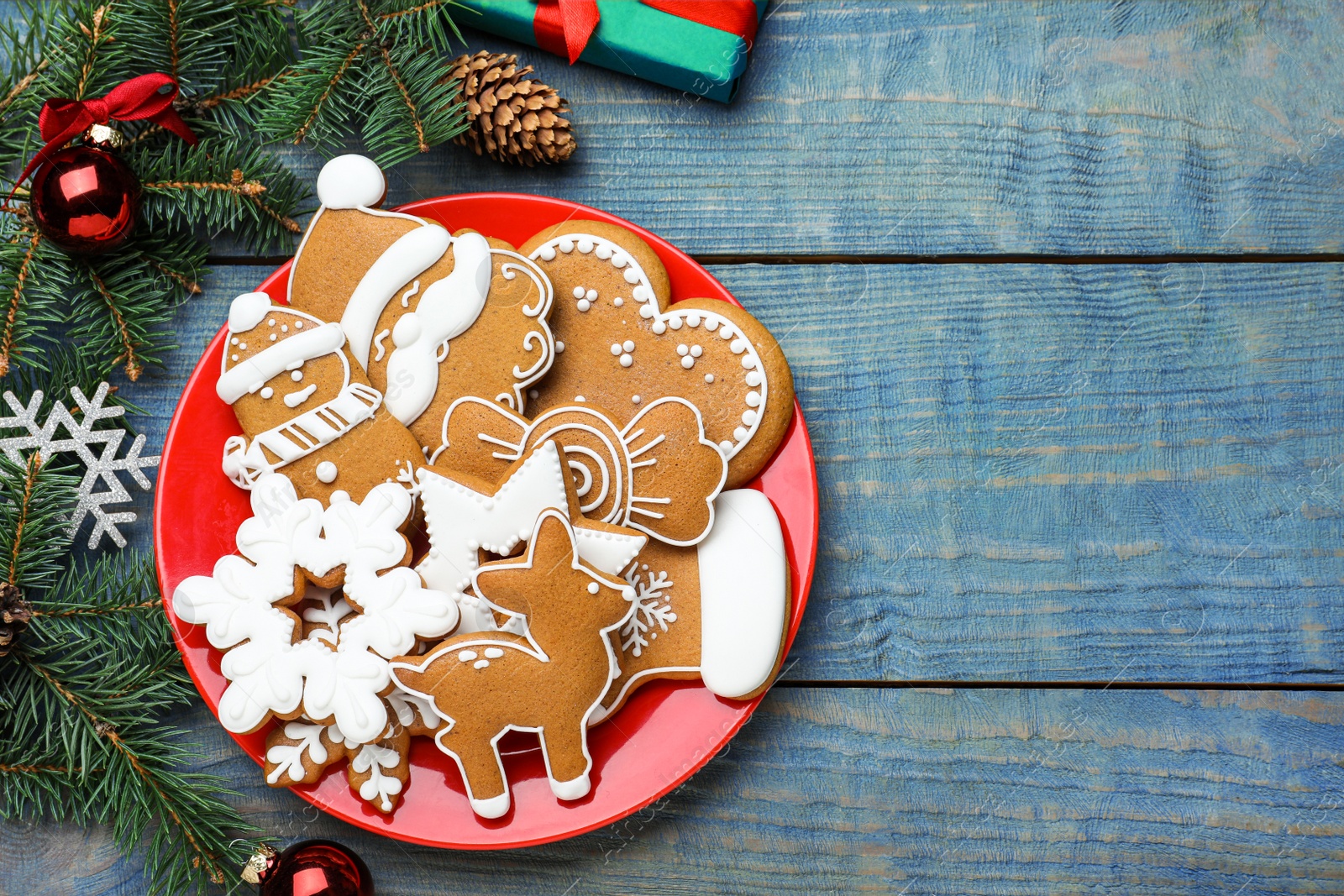 Photo of Delicious Christmas cookies on blue wooden table, flat lay. Space for text