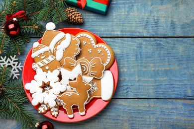 Photo of Delicious Christmas cookies on blue wooden table, flat lay. Space for text
