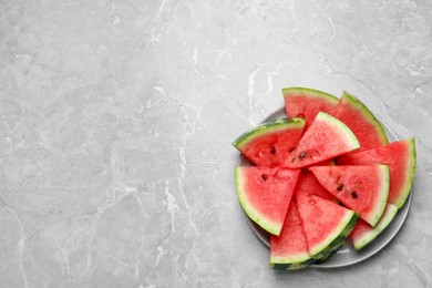 Photo of Slices of tasty ripe watermelon on light grey marble table, top view