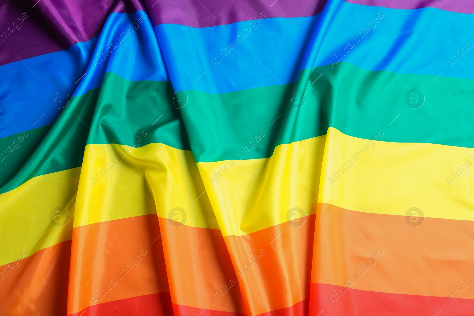 Photo of Bright rainbow gay flag as background. LGBT community