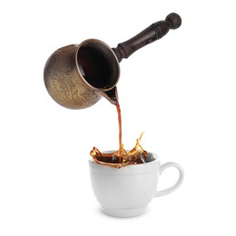 Pouring freshly brewed aromatic coffee from turkish pot into cup. Objects in air on white background