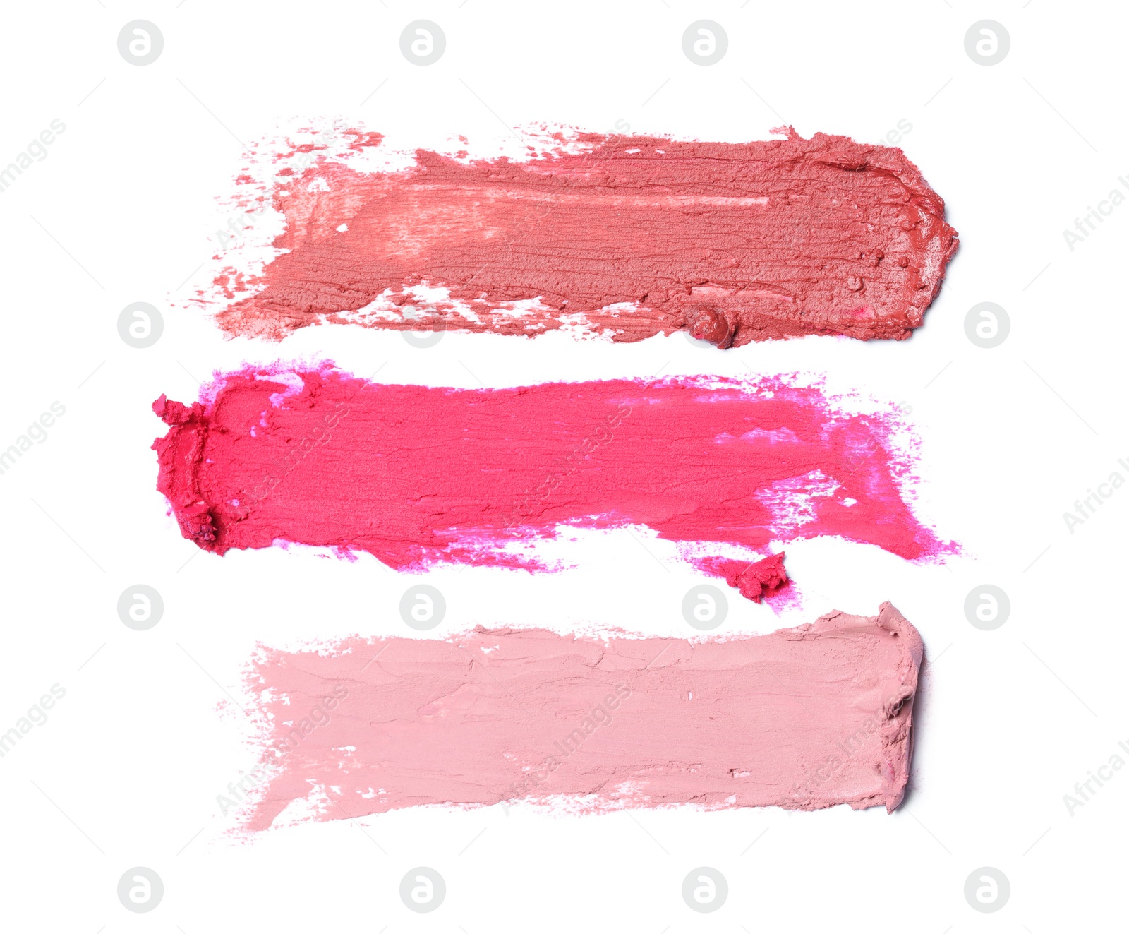 Photo of Smears of different beautiful lipsticks on white background, top view