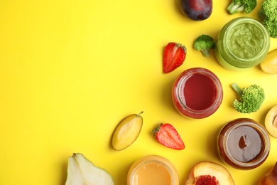 Flat lay composition with healthy baby food and ingredients on yellow background. Space for text