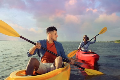 Beautiful couple kayaking on river. Summer activity