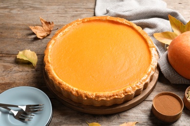 Photo of Fresh delicious homemade pumpkin pie served on wooden table