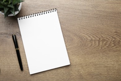 Photo of Flat lay composition with notebook on wooden table