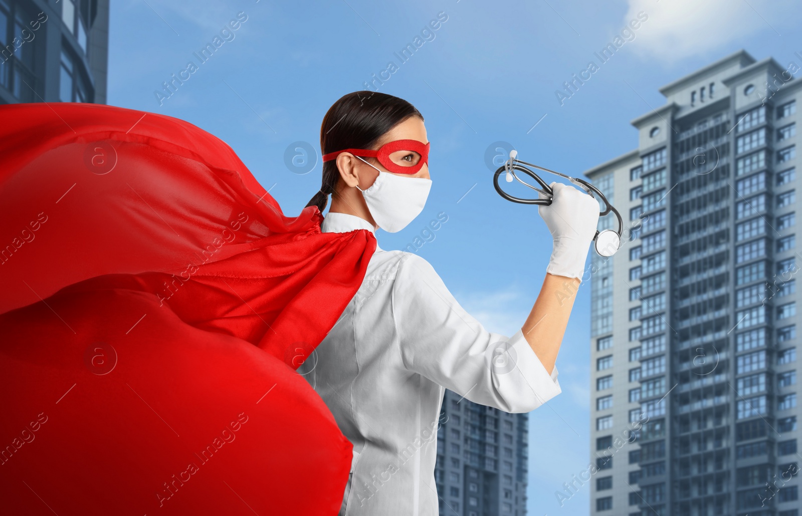 Image of Doctor dressed as superhero on city background. Medical workers fighting with dangerous diseases