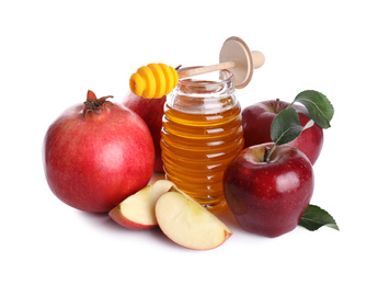 Honey, apples and pomegranates on white background. Jewish New Year (Rosh Hashanah) holiday