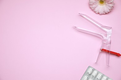 Gynecological treatment. Sterile speculum, pills and gerbera flower on pink background, flat lay. Space for text