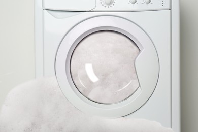 Image of Foam coming out from broken washing machine during laundering