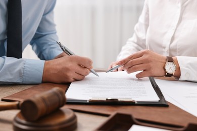 Lawyers working with documents at table in office, closeup