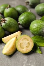 Fresh green feijoa fruits on grey table, closeup