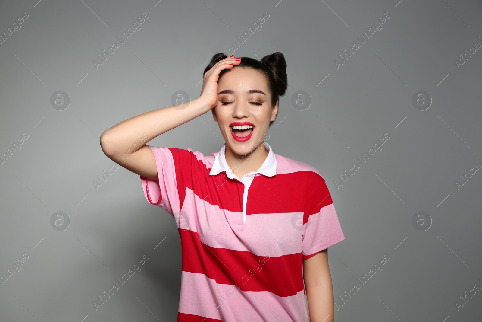 Photo of Portrait of beautiful young woman on grey background