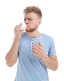 Young man suffering from allergy on white background