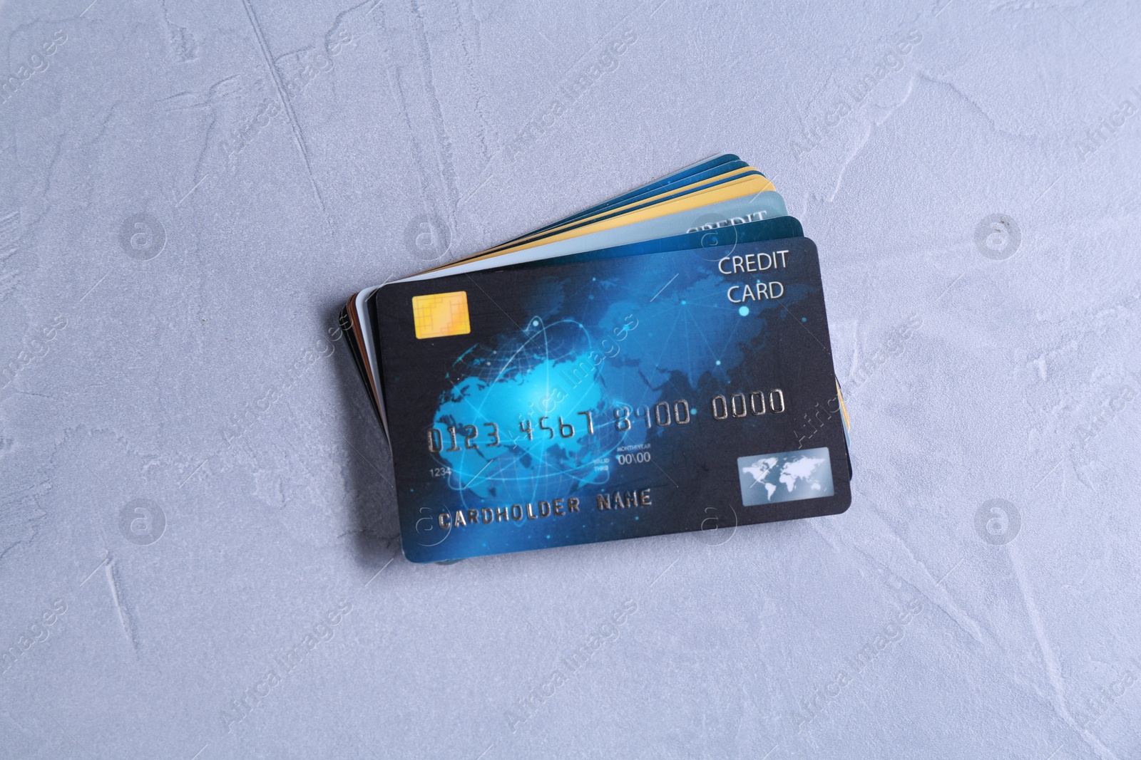 Photo of Credit cards on grey textured table, top view