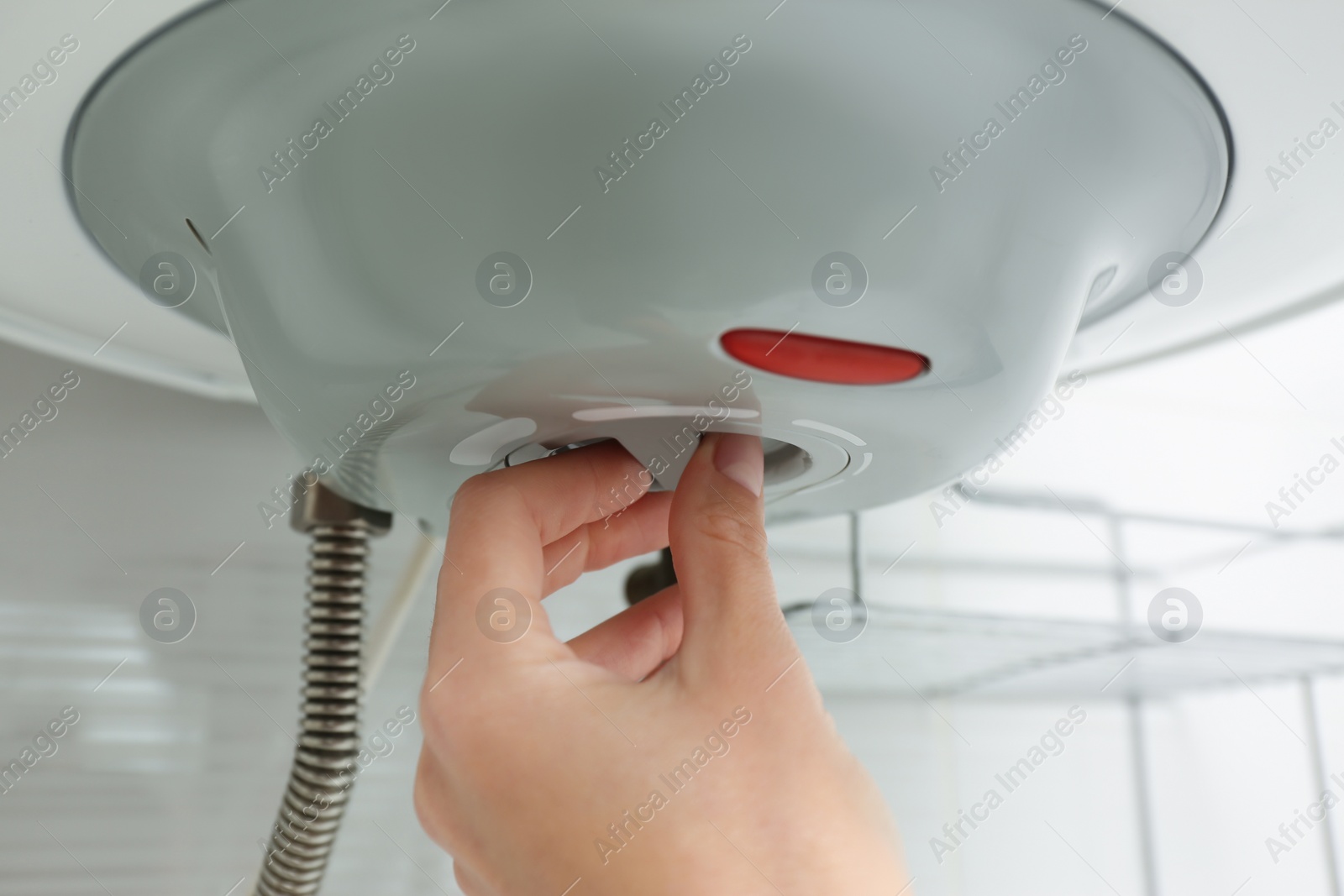 Photo of Woman adjusting maximum energy efficiency indicator indoors, closeup. Boiler installation