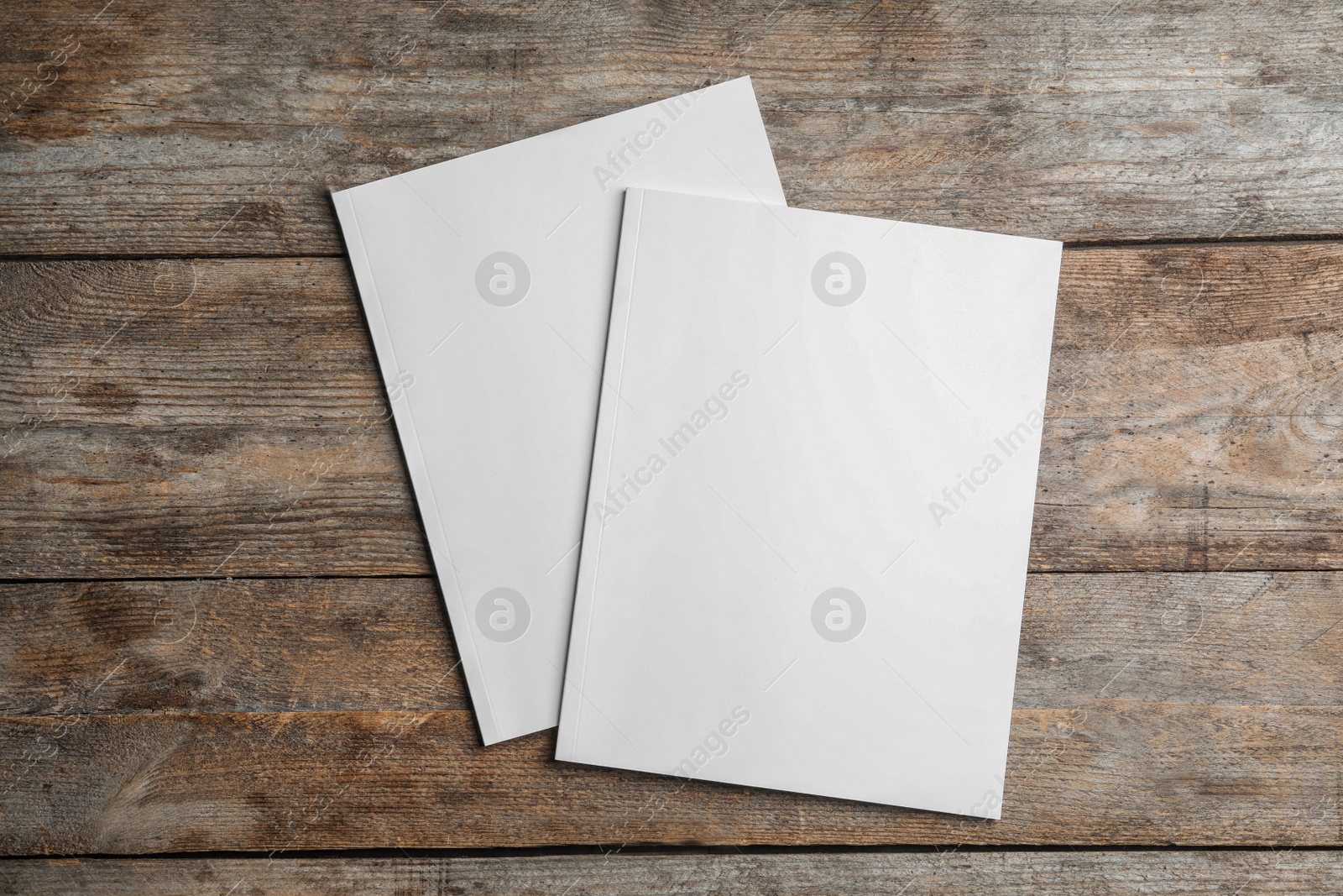 Photo of Brochures with blank cover on wooden background, top view. Mock up for design