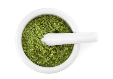 Photo of Mortar of tasty pesto sauce and pestle isolated on white, top view