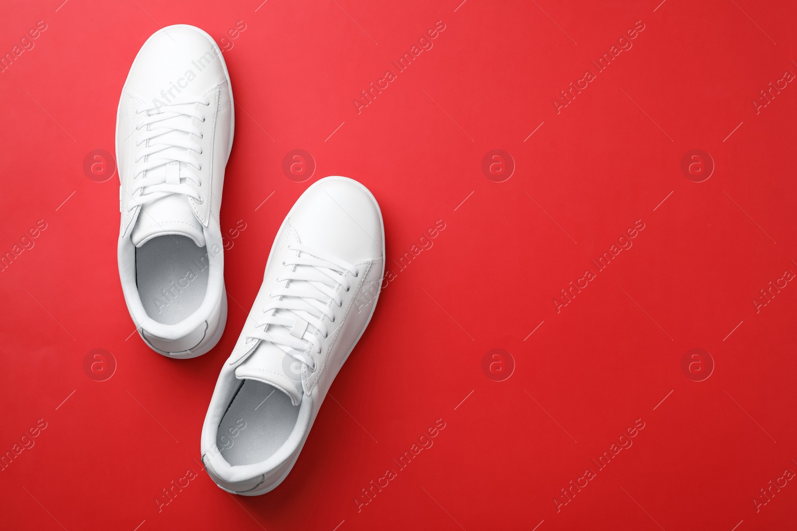 Photo of Pair of sneakers on color background, flat lay. Space for text