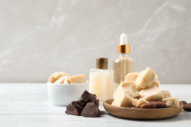 Photo of Organic cocoa butter on white wooden table