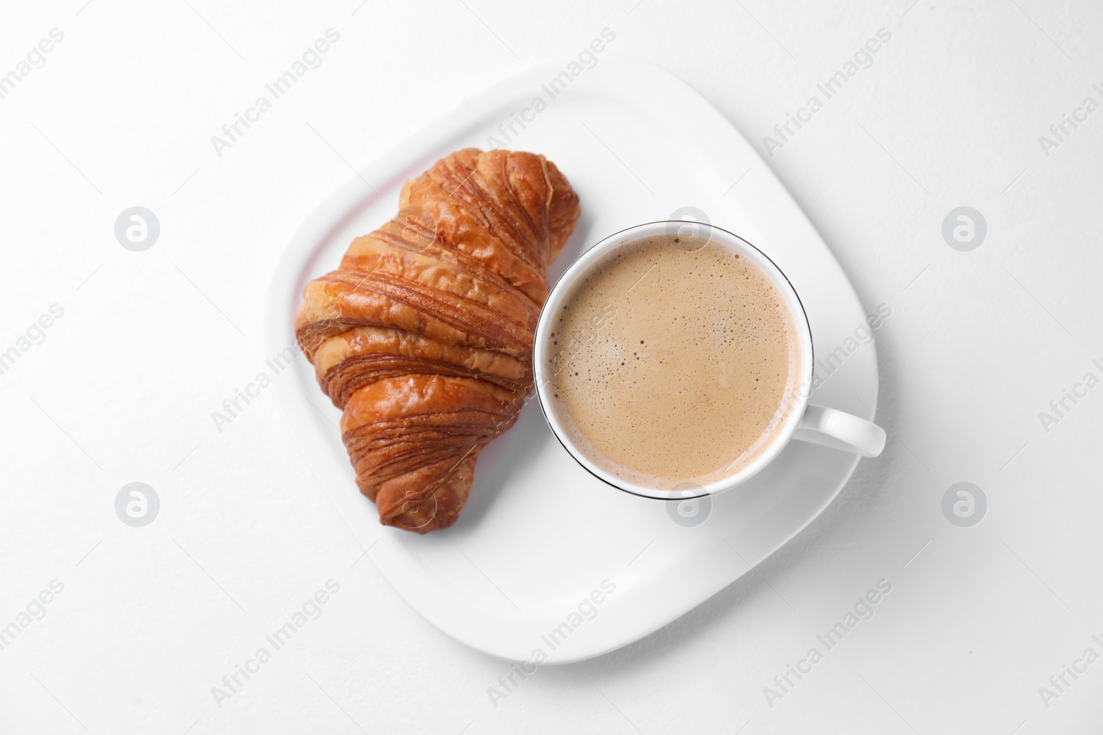 Photo of Fresh croissant and coffee on white background, top view. Tasty breakfast