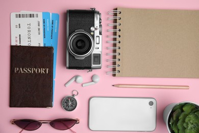 Photo of Flat lay composition with passport, tickets and travel items on pink background