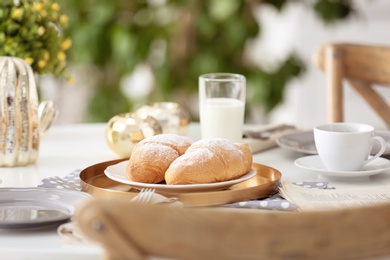 Tasty breakfast with fresh croissants on table