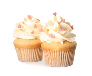Photo of Tasty cupcakes with heart shaped sprinkles for Valentine's Day on white background