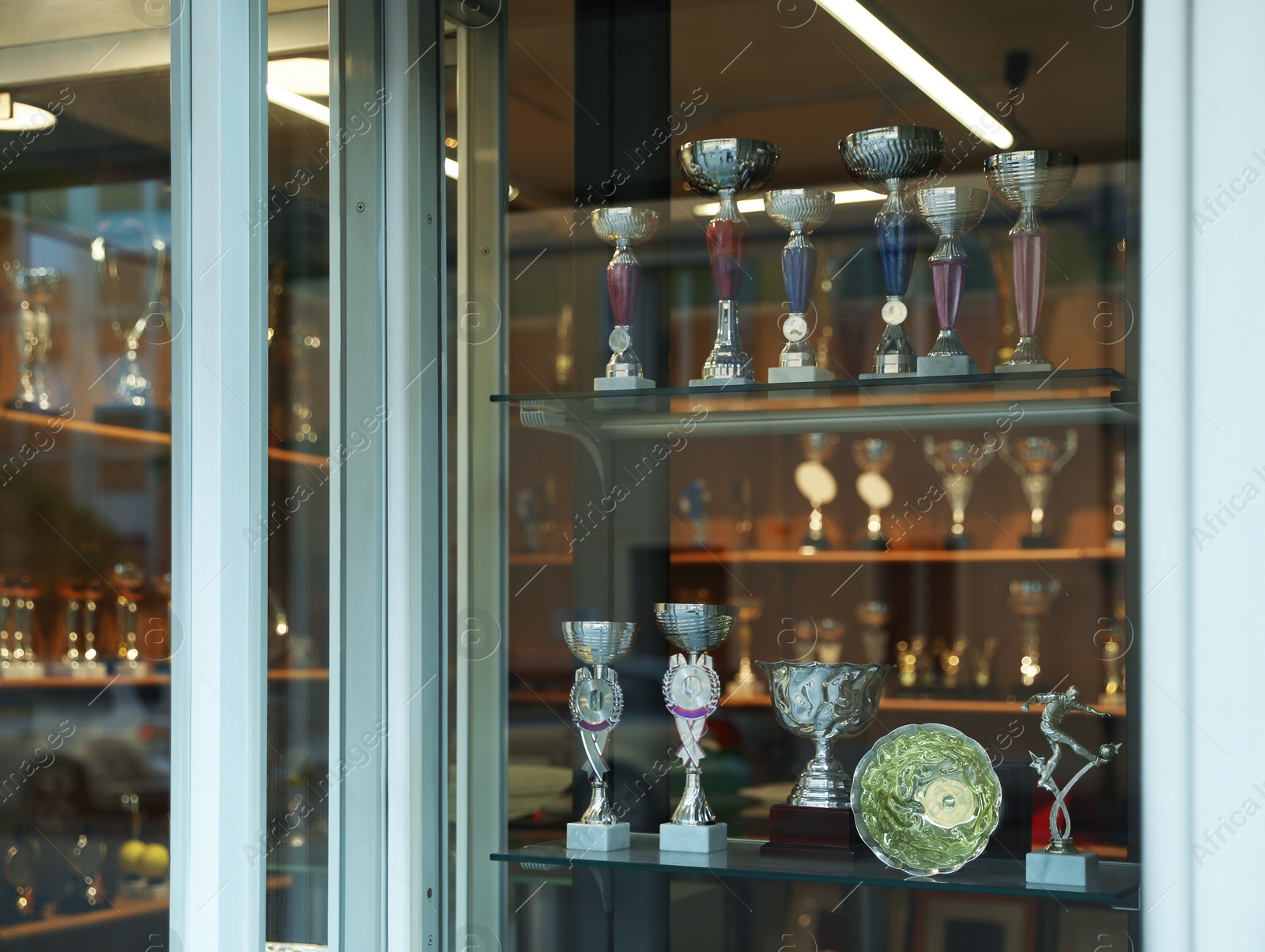 Photo of Showcase with different trophy cups in shop, view from outside