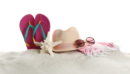 Photo of Different beach accessories on sand against white background