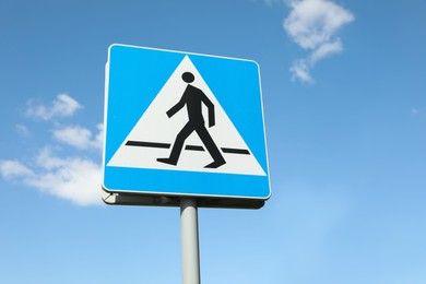 Photo of Traffic sign Pedestrian Crossing against blue sky, low angle view