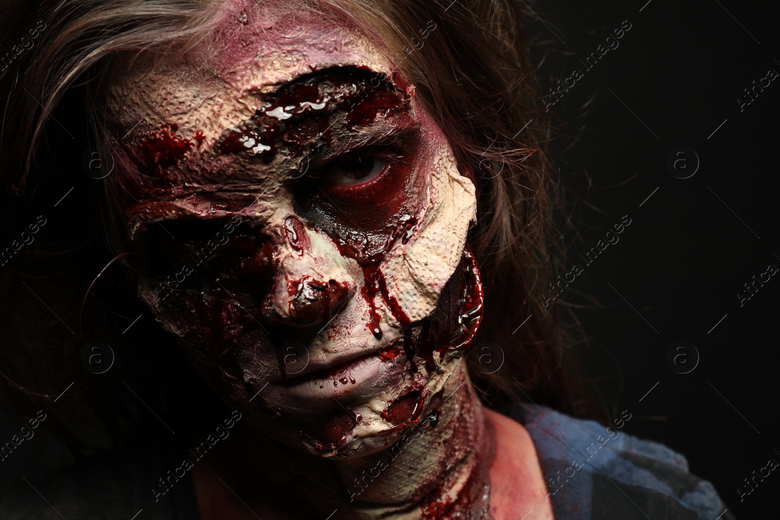 Photo of Scary zombie on dark background, closeup. Halloween monster