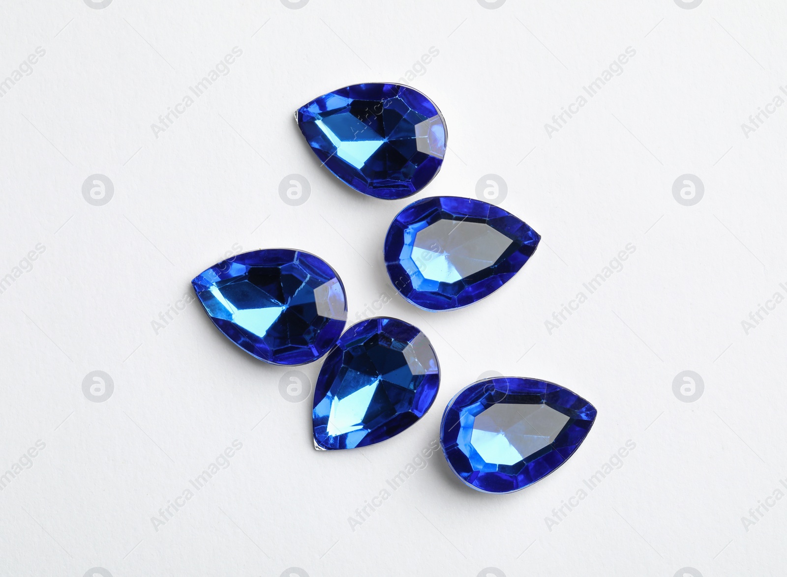 Image of Beautiful gemstones on white background, top view