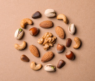 Photo of Flat lay composition with organic mixed nuts on color background