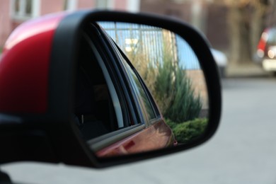 Side rear view mirror of modern car outdoors, closeup