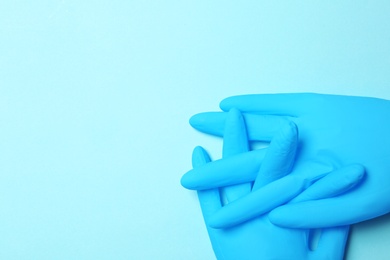 Photo of Flat lay composition with medical gloves on color background. Space for text
