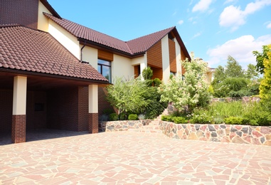 Landscape with modern house and beautiful garden on sunny day