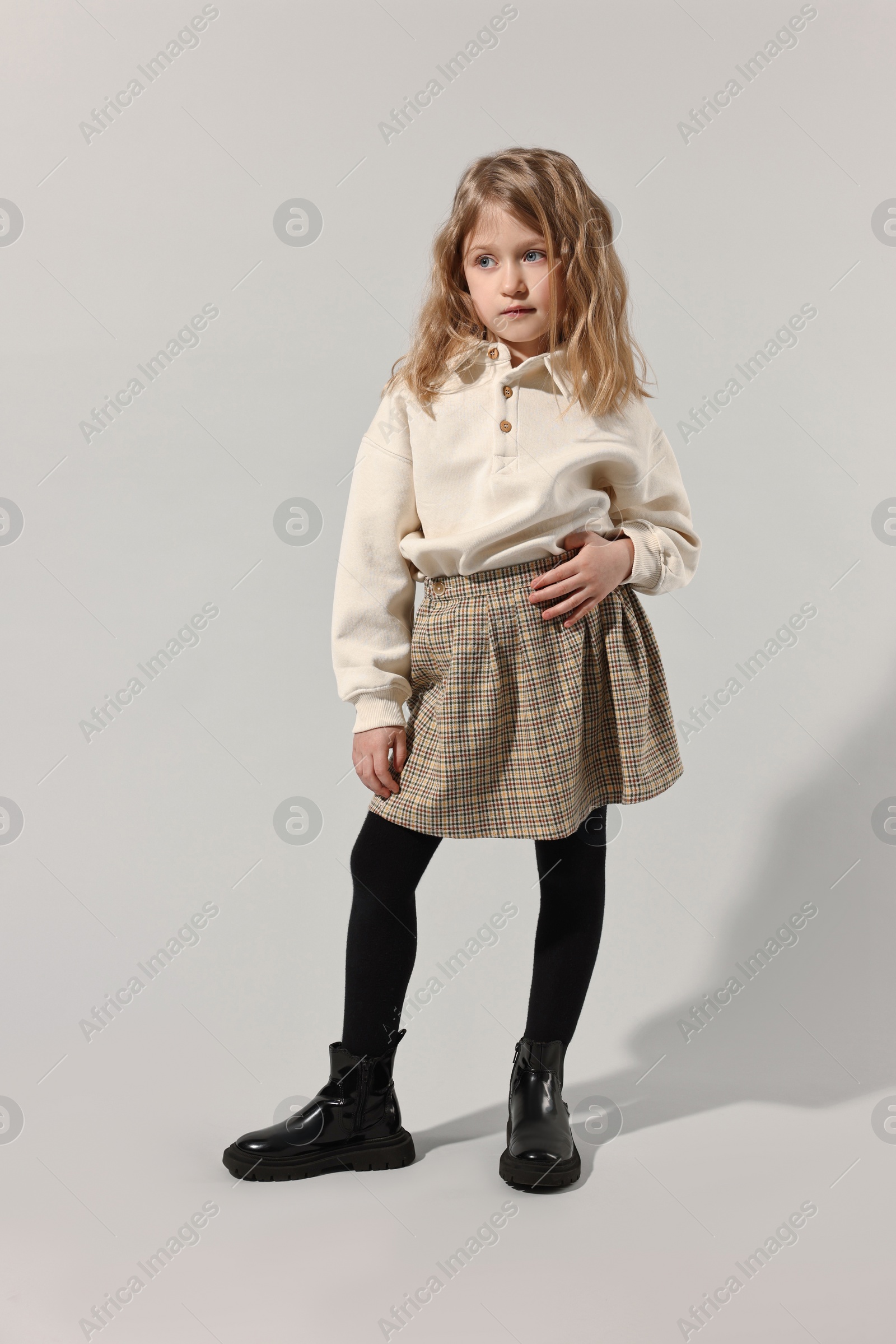 Photo of Fashion concept. Stylish girl posing on light grey background