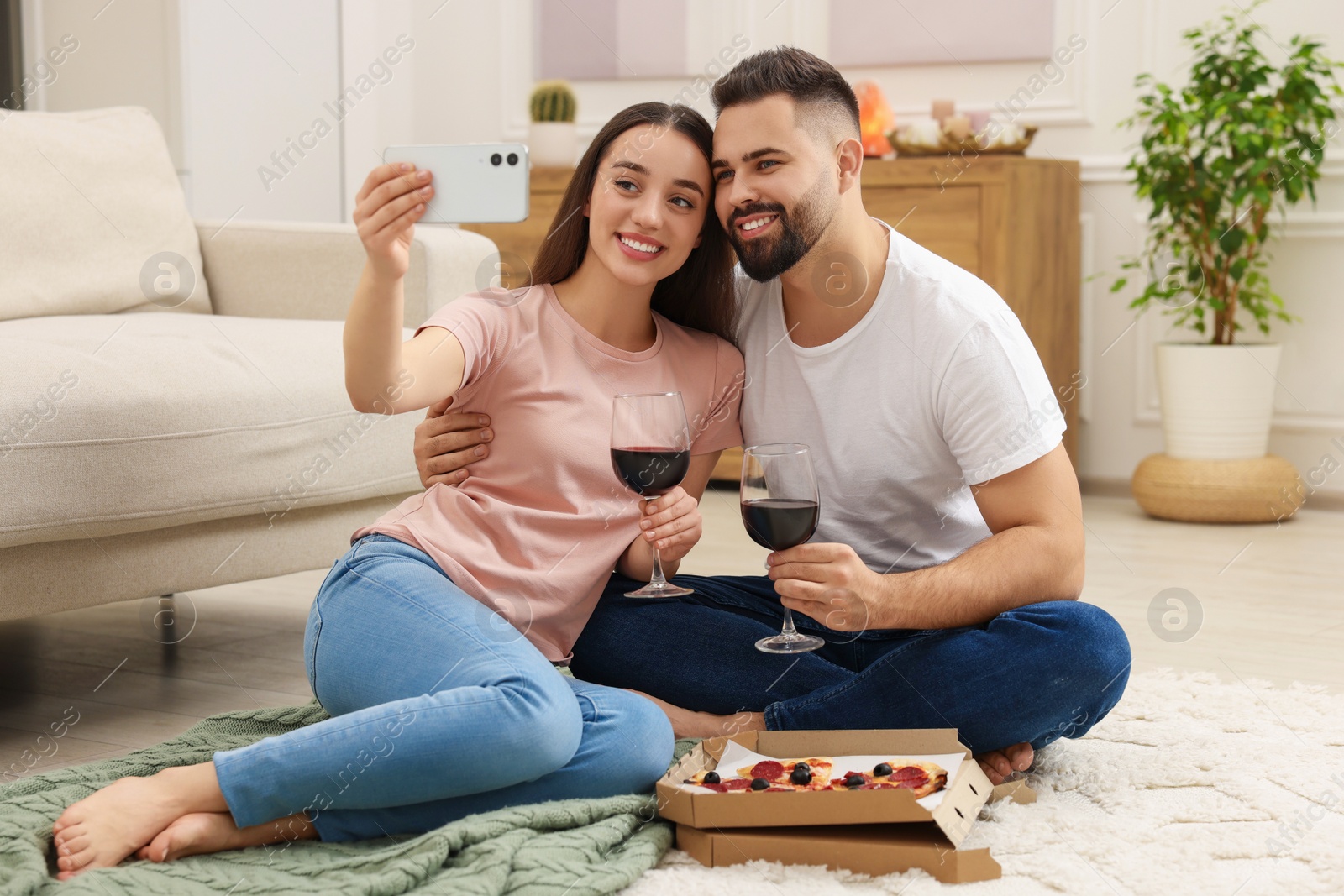 Photo of Affectionate young couple spending time together at home