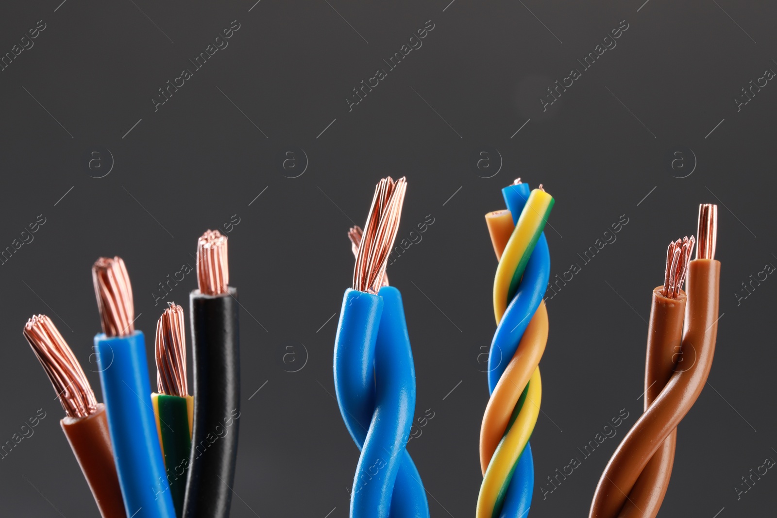 Photo of New colorful electrical wires on gray background