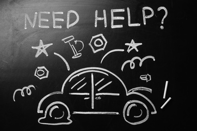 Drawing of broken car and phrase "NEED HELP?" on chalkboard