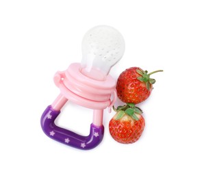 Photo of Empty nibbler and strawberries on white background, top view. Baby feeder