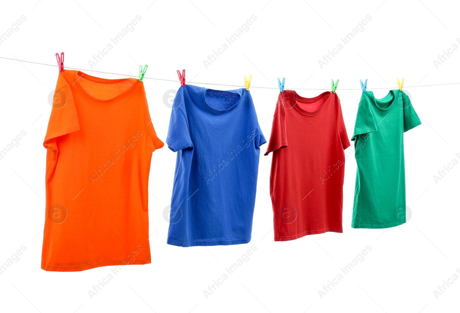 Photo of Colorful t-shirts drying on washing line isolated on white