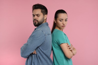 Photo of Resentful couple with crossed arms on pink background