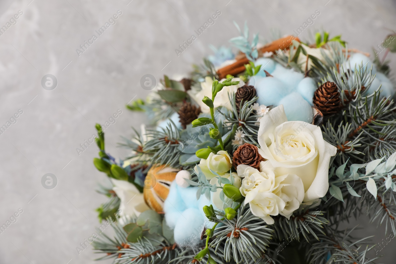 Photo of Beautiful wedding winter bouquet on grey table, top view. Space for text