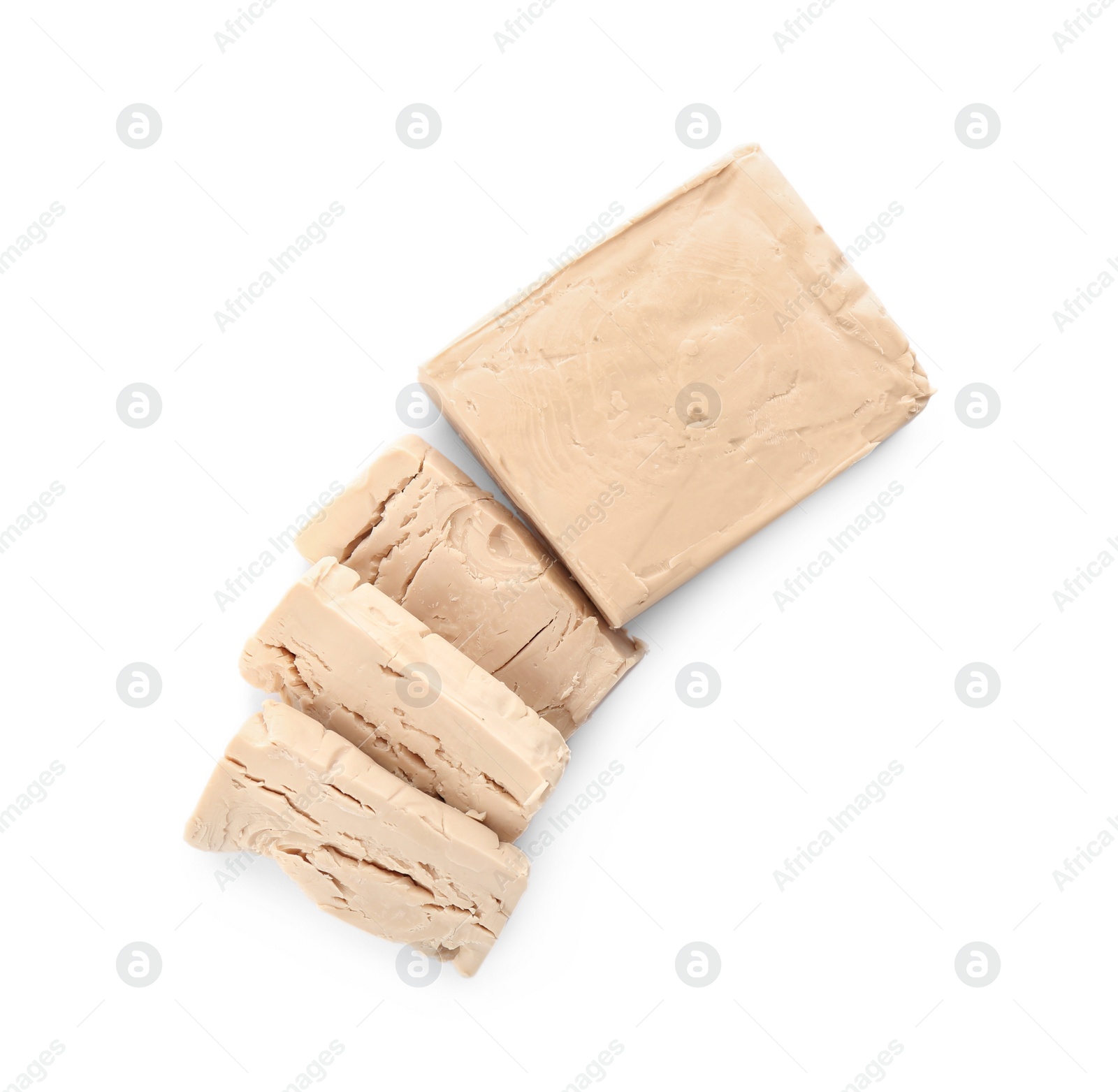 Photo of Pieces of compressed yeast on white background, top view