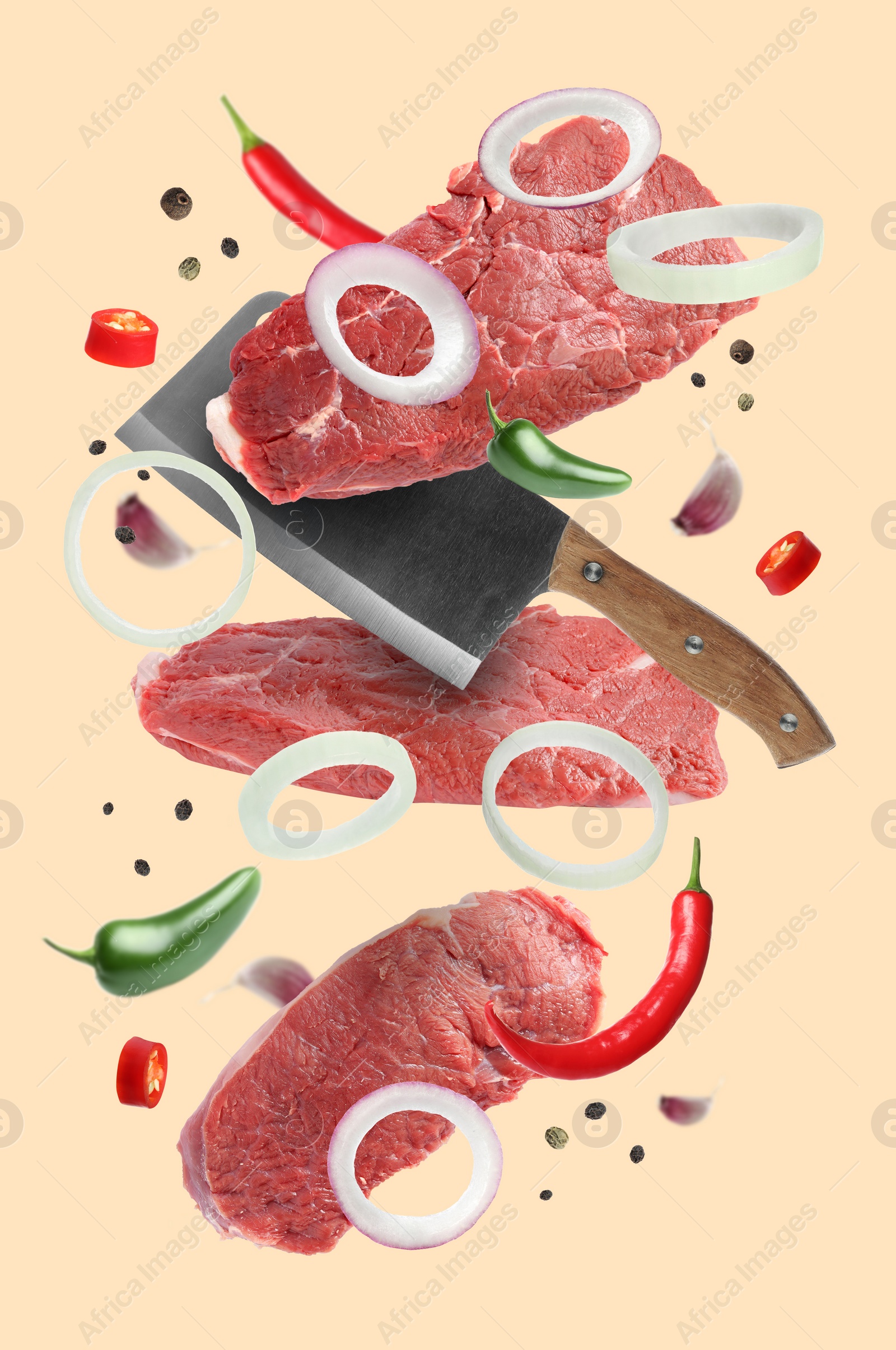 Image of Beef meat, different spices and cleaver knife falling on beige background